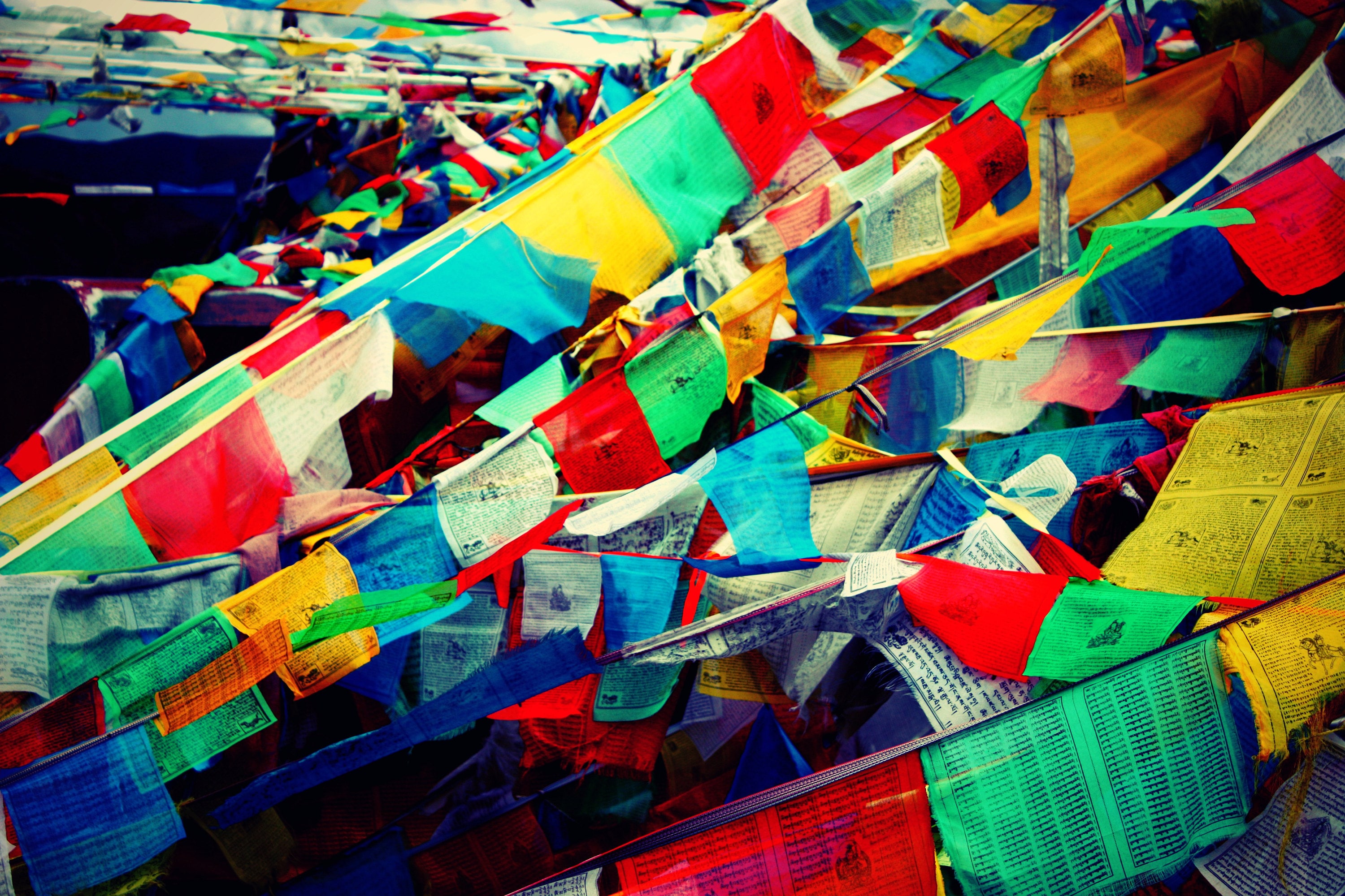 A tangle of colourful prayer flags high up on a pass.