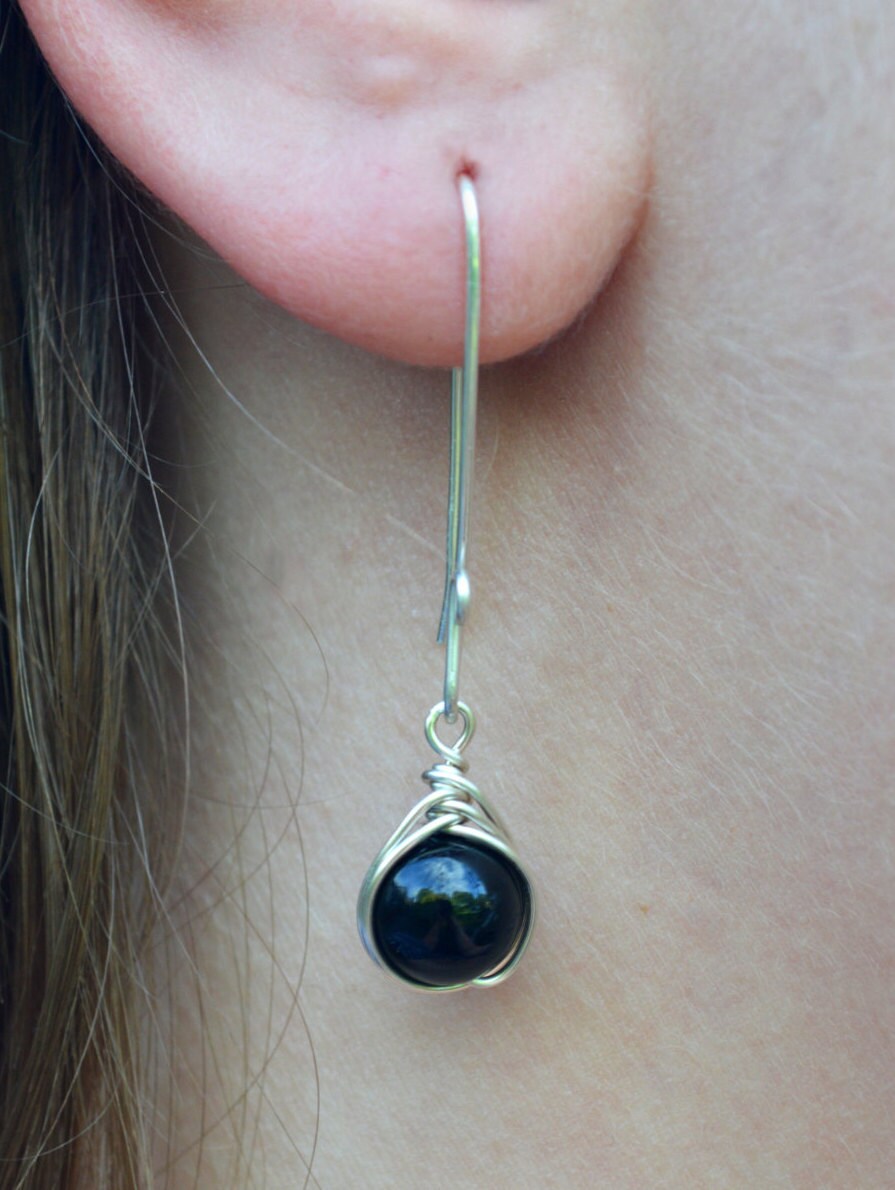 Ear wearing long drop earrings