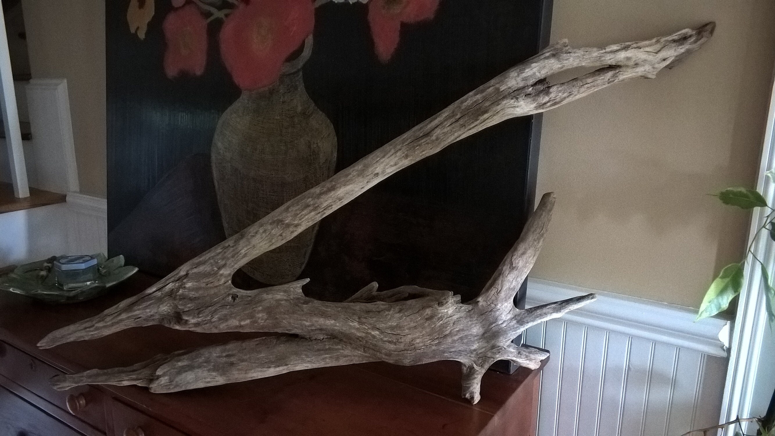 Driftwood art piece with an angular shape hand like accent.