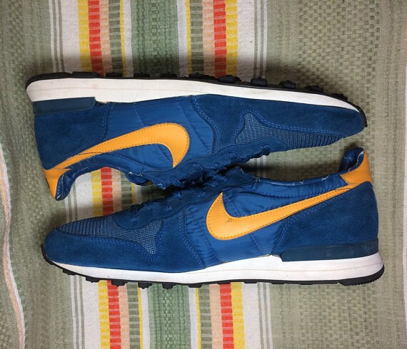 blue nikes with yellow swoosh