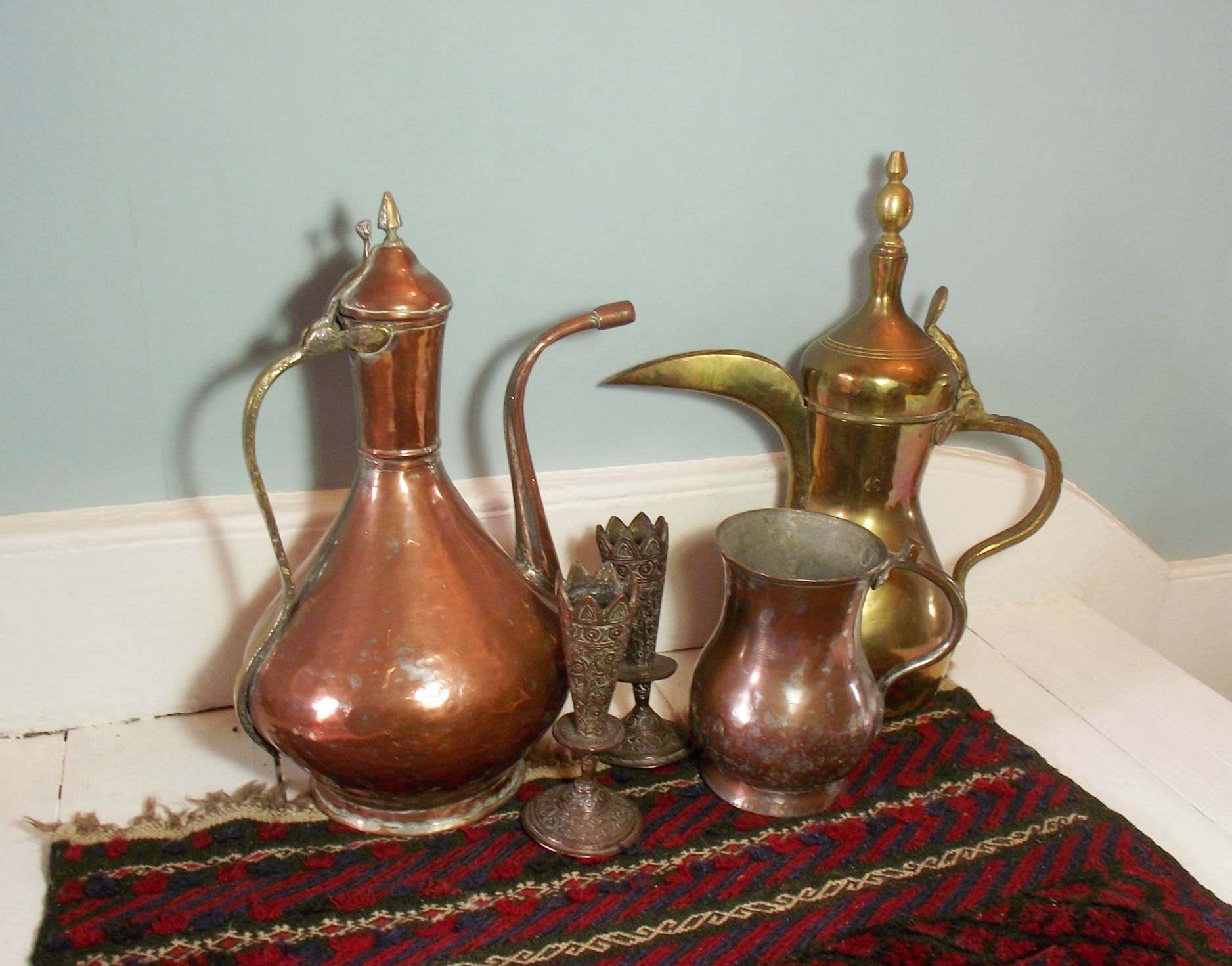 Collection of bohemian decor available in the Suki and Polly shop: an antique middle eastern copper coffee pot, an Arabic brass coffee pot, antique Kashmiri Vases and an antique copper tankard.