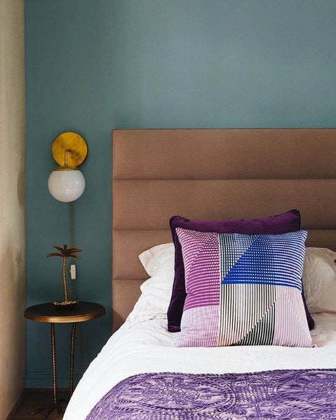 Leo sconce over brass bedside table