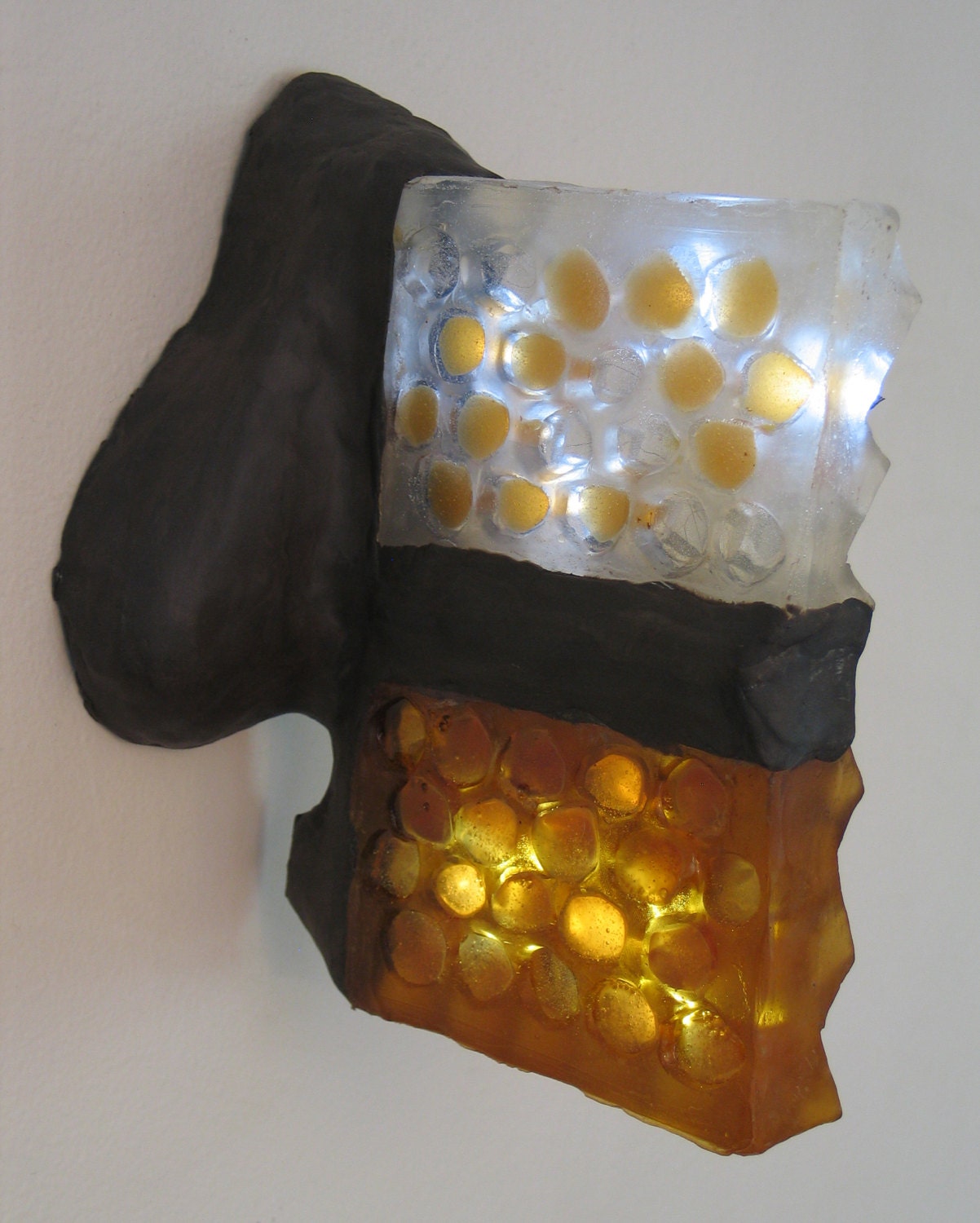 Translucent amber honeycomb with embedded LEDs .  Apis habilis:  Honeycomb Number 6