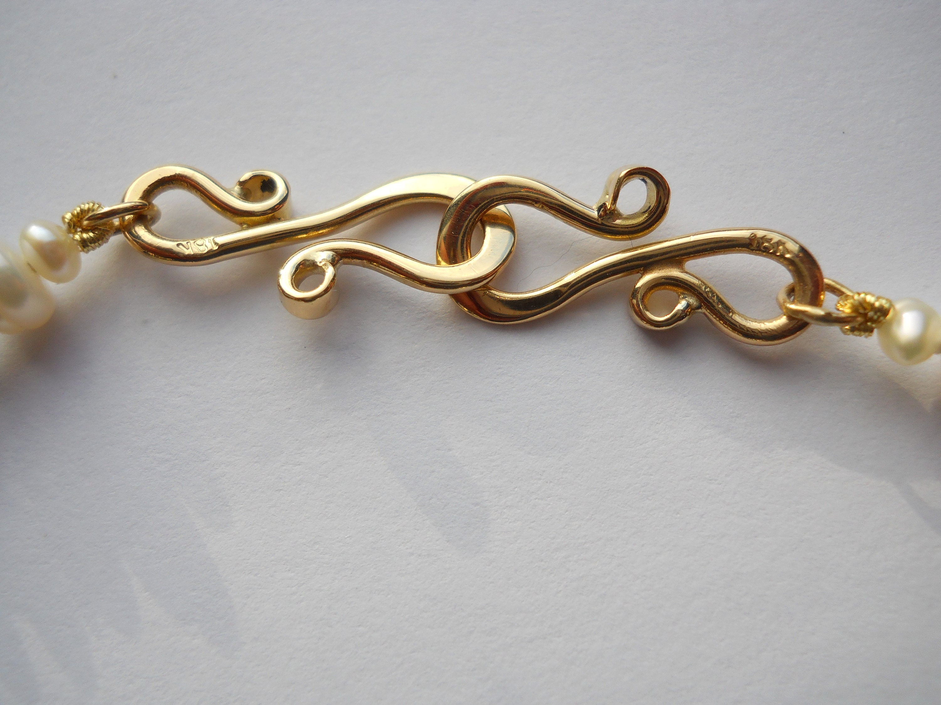 18K gold hand forged clasp details.