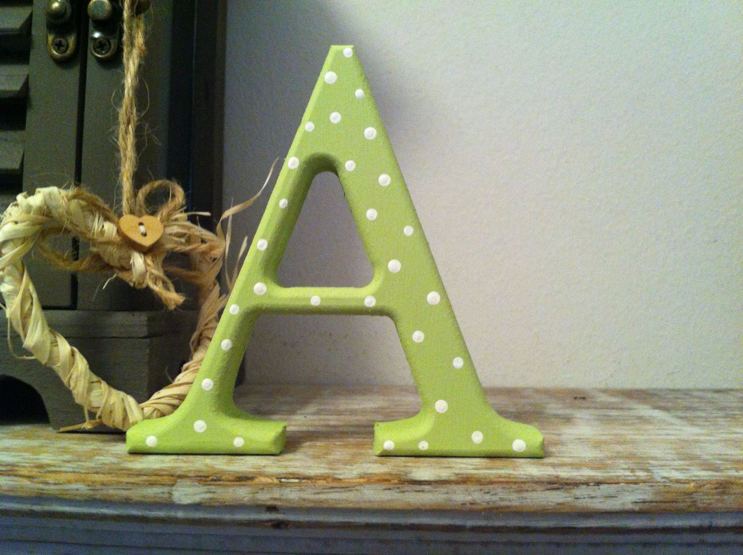 Letter A in Georgia Font, with a lime green and white polka dot finish