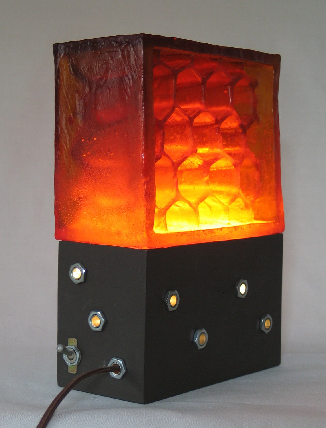 translucent amber honeycomb illuminated by a light hidden in opaque base