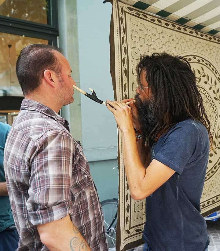 My friend Ryan receiving a rapé from a fellow shaman type medicine man at a market in Zürich.