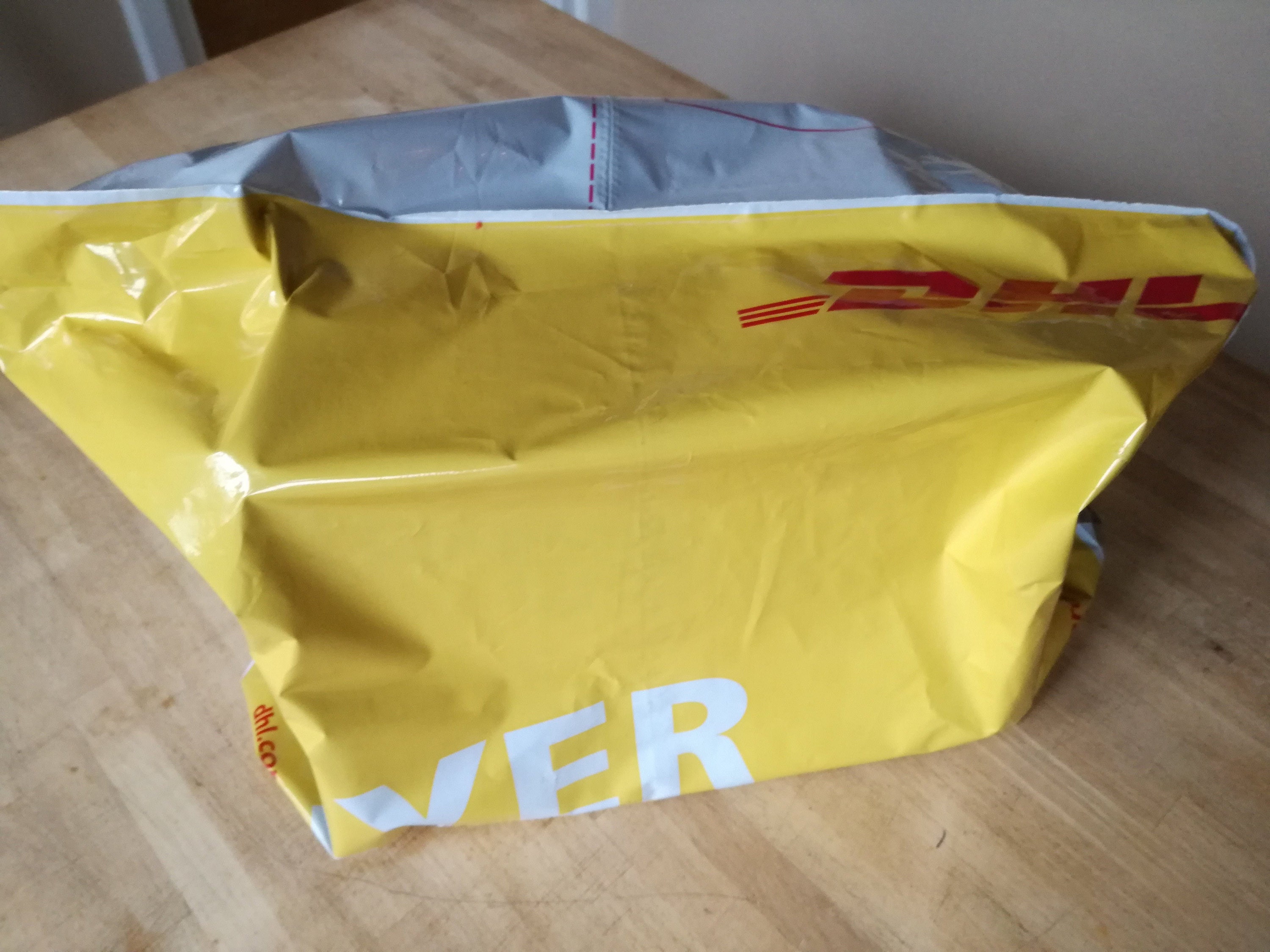 Small parcel covered by a DHL flyer - package is under 2kg