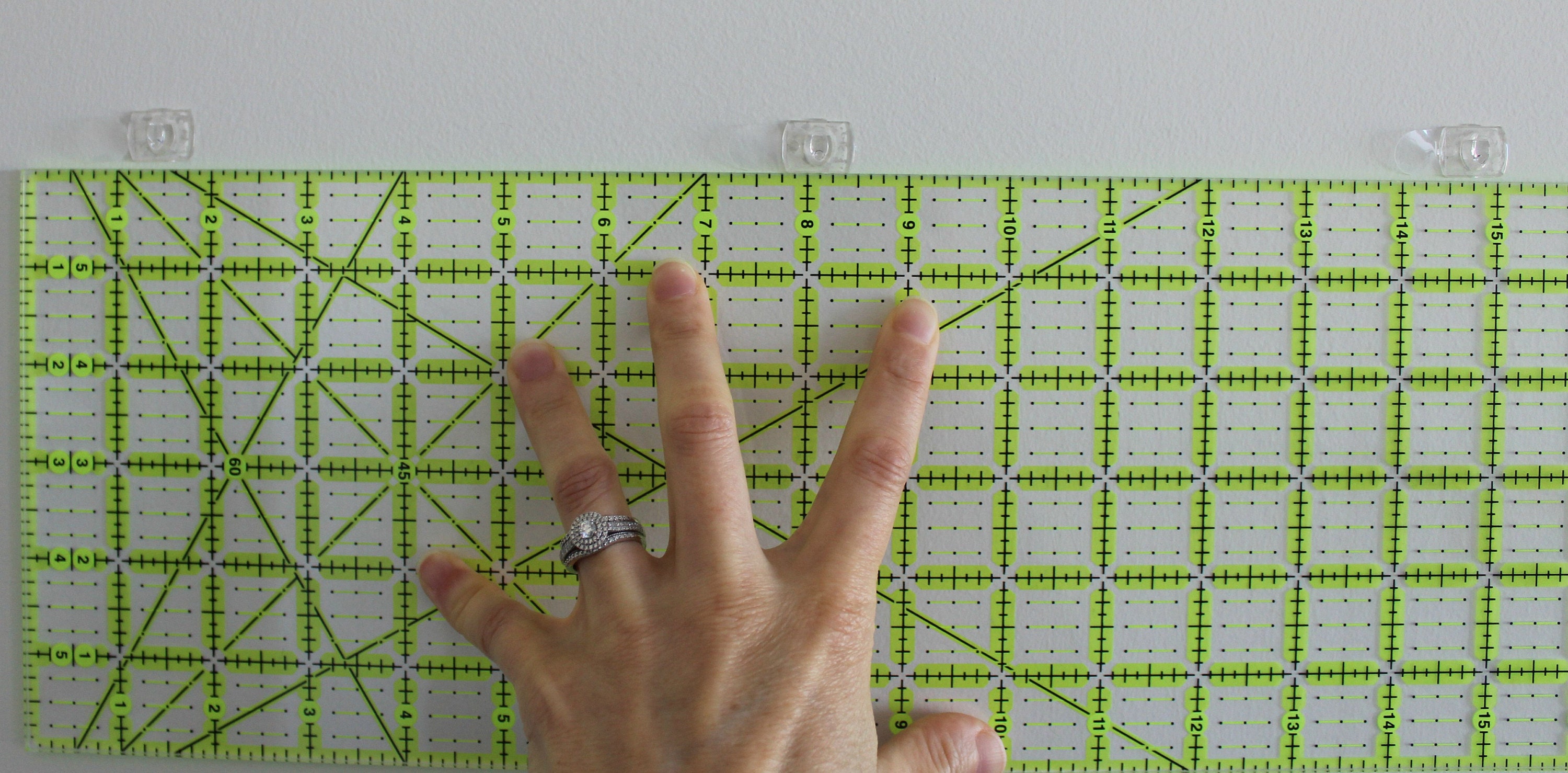 Place your ruler on the wall and place the hooks.